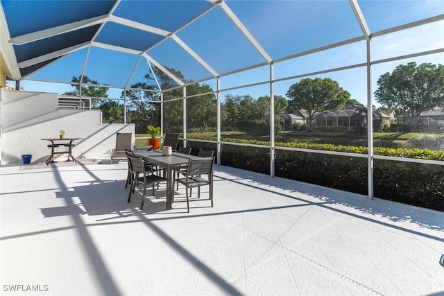 view of patio / terrace with outdoor dining area and a lanai