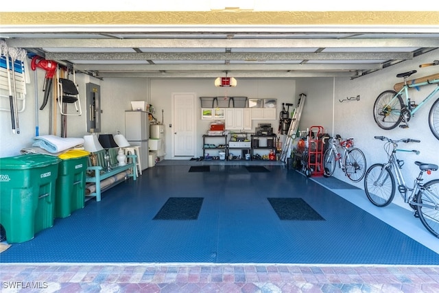 garage featuring electric panel and water heater