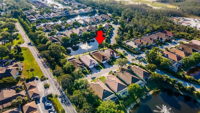 bird's eye view with a residential view and a water view