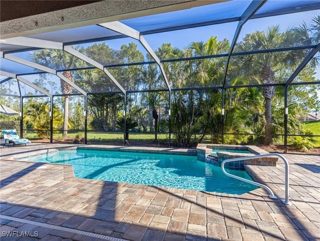 view of pool featuring glass enclosure, a patio area, and a pool with connected hot tub