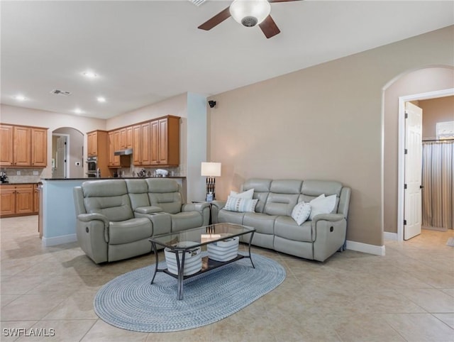 living area with visible vents, baseboards, ceiling fan, recessed lighting, and arched walkways