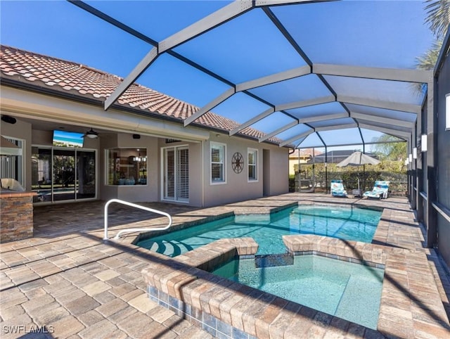 view of pool featuring a patio, ceiling fan, and a pool with connected hot tub