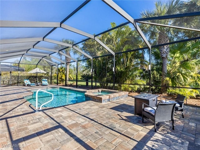 view of pool with a patio, an outdoor fire pit, a lanai, and a pool with connected hot tub