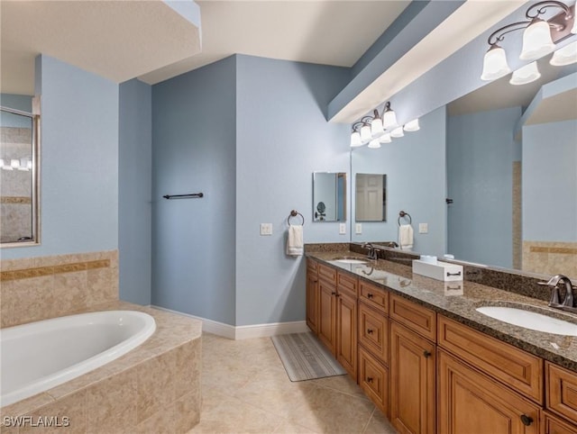 full bathroom with tile patterned floors, double vanity, a garden tub, and a sink