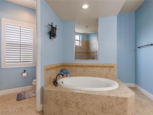 bathroom featuring toilet, a tile shower, tile patterned flooring, baseboards, and a bath