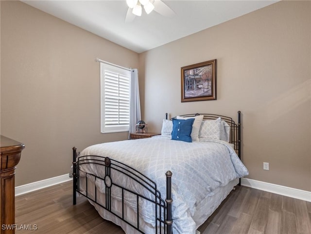 bedroom with baseboards, wood finished floors, and a ceiling fan