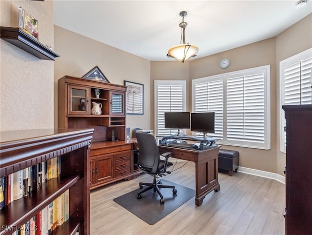 office area featuring baseboards and light wood-style floors