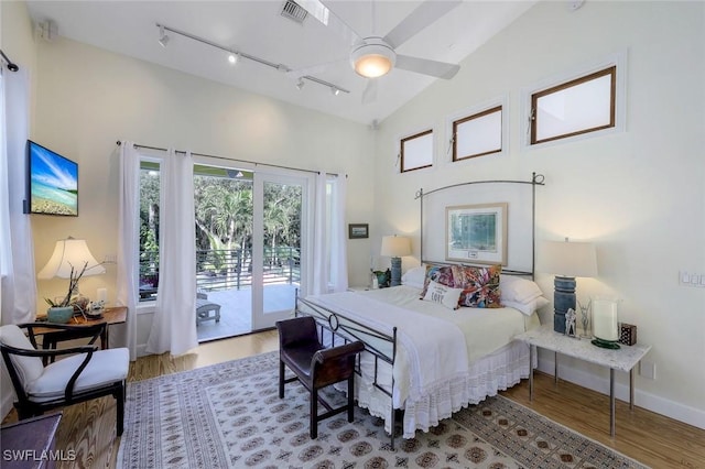 3643 N Rd, Naples, FL 34104 - bedroom featuring access to exterior, high vaulted ceiling, wood finished floors, baseboards, and visible vents