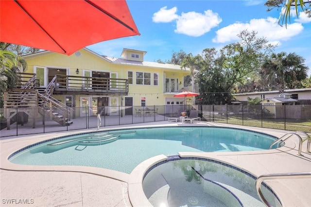 3643 N Rd, Naples, FL 34104 - view of pool featuring a pool with connected hot tub, stairway, fence, and a patio