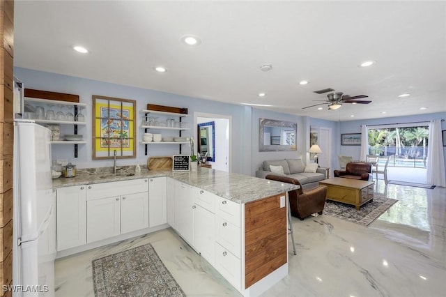 3643 N Rd, Naples, FL 34104 - kitchen featuring light stone counters, freestanding refrigerator, open shelves, marble finish floor, and recessed lighting