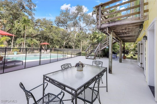 3643 N Rd, Naples, FL 34104 - view of patio featuring outdoor dining space, stairs, fence, and a fenced in pool