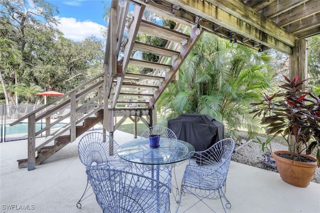 3643 N Rd, Naples, FL 34104 - view of patio with stairs, outdoor dining area, grilling area, and a fenced in pool