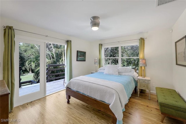 3643 N Rd, Naples, FL 34104 - bedroom featuring access to exterior, light wood-style flooring, multiple windows, and visible vents