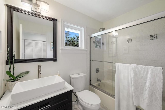 3643 N Rd, Naples, FL 34104 - full bathroom with toilet, vanity, and bath / shower combo with glass door