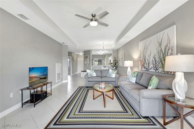 7831 Regal Heron Cir Unit 304, Naples, FL 34104 - living area featuring a chandelier, ceiling fan, light tile patterned floors, a raised ceiling, and baseboards
