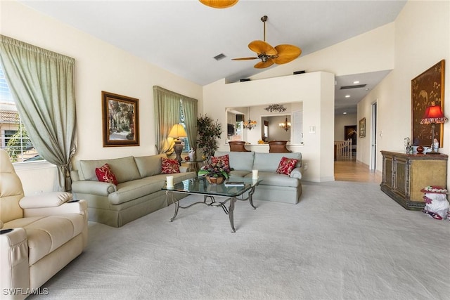 living room featuring visible vents, carpet floors, high vaulted ceiling, and ceiling fan with notable chandelier