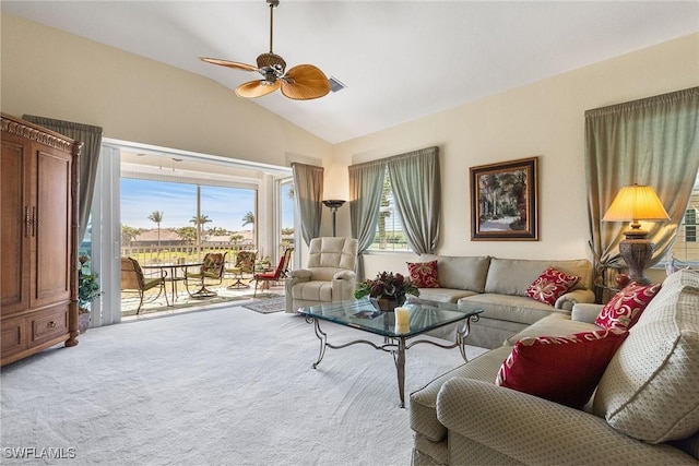 living area with a ceiling fan, carpet flooring, and vaulted ceiling