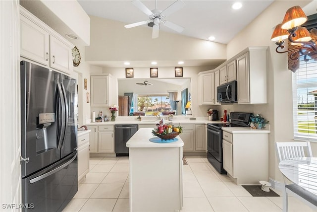 kitchen with a kitchen island, black appliances, a ceiling fan, and light countertops