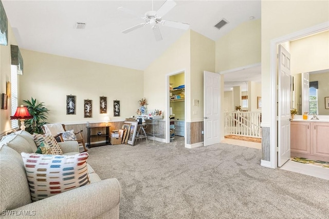 living room with carpet, visible vents, and high vaulted ceiling