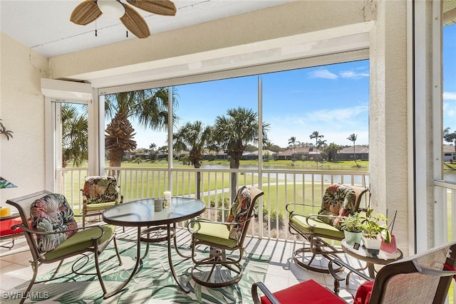 sunroom / solarium featuring ceiling fan