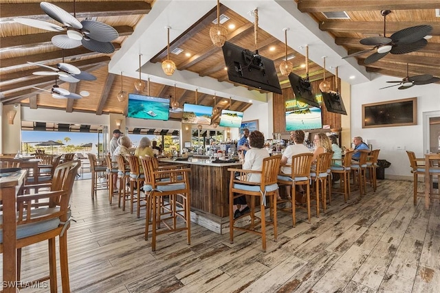 bar featuring ceiling fan, beamed ceiling, wood finished floors, and wooden ceiling