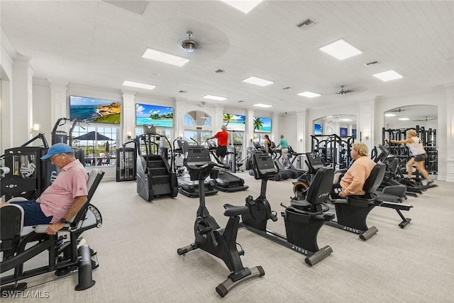 workout area with carpet flooring, decorative columns, and visible vents