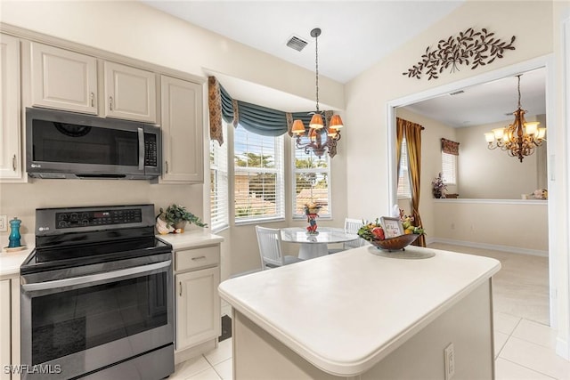 kitchen with decorative light fixtures, a notable chandelier, stainless steel electric range oven, and visible vents