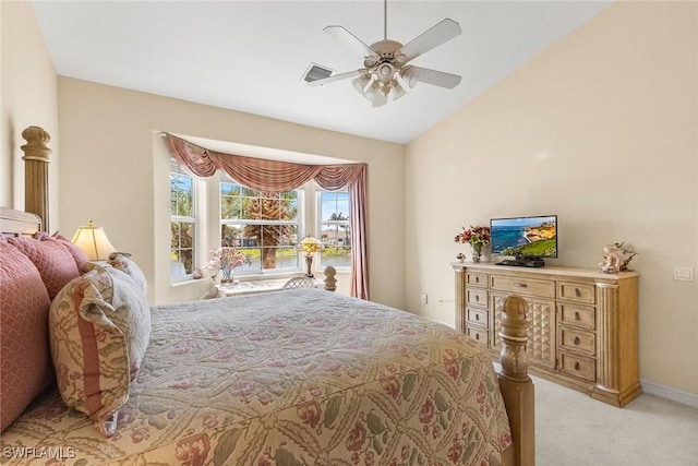 bedroom with lofted ceiling, light colored carpet, baseboards, and ceiling fan