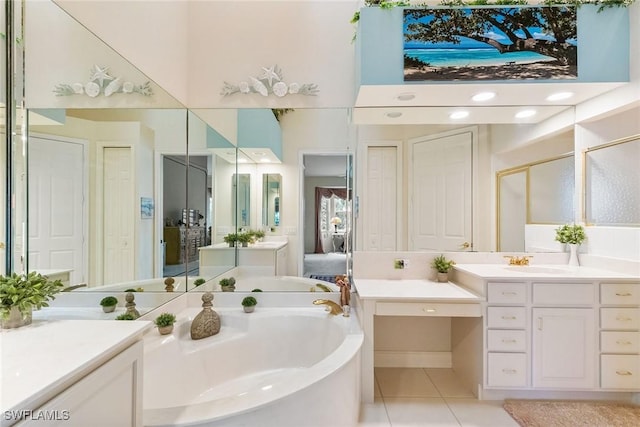 ensuite bathroom with tile patterned flooring, a closet, a stall shower, a bath, and vanity