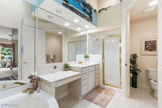 bathroom featuring vanity, toilet, a stall shower, and tile patterned flooring