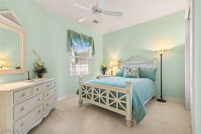 bedroom with a ceiling fan, baseboards, and light carpet