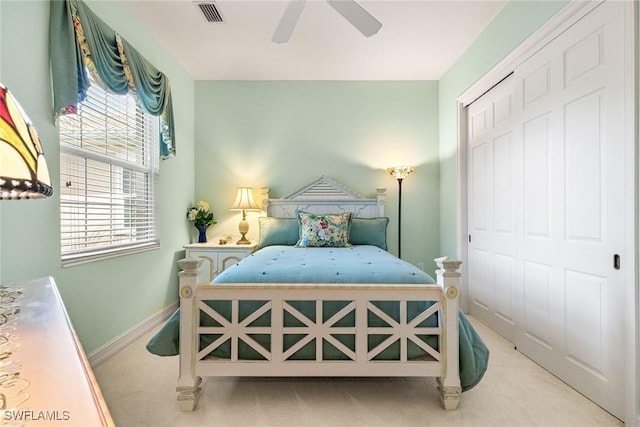 bedroom with visible vents, a ceiling fan, a closet, carpet floors, and baseboards