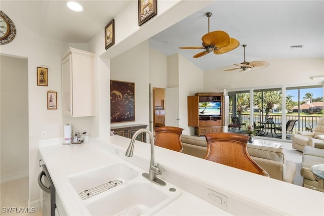 5979 Trophy Dr Unit 1604, Naples, FL 34110 - kitchen featuring a sink, white cabinetry, open floor plan, ceiling fan, and high vaulted ceiling