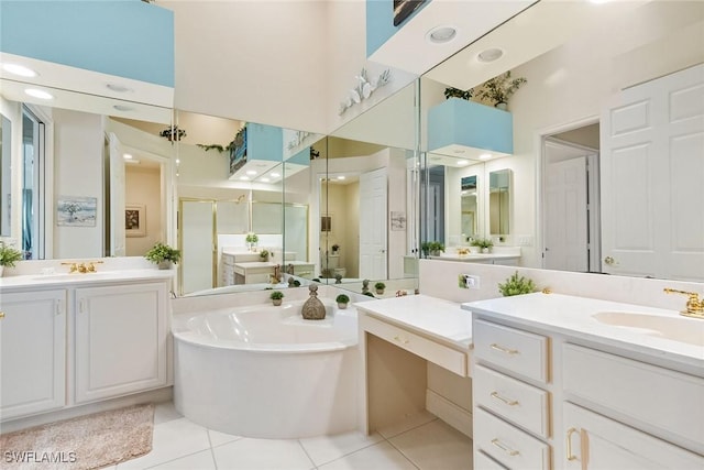 5979 Trophy Dr Unit 1604, Naples, FL 34110 - full bathroom with two vanities, tile patterned flooring, a shower stall, a garden tub, and a high ceiling