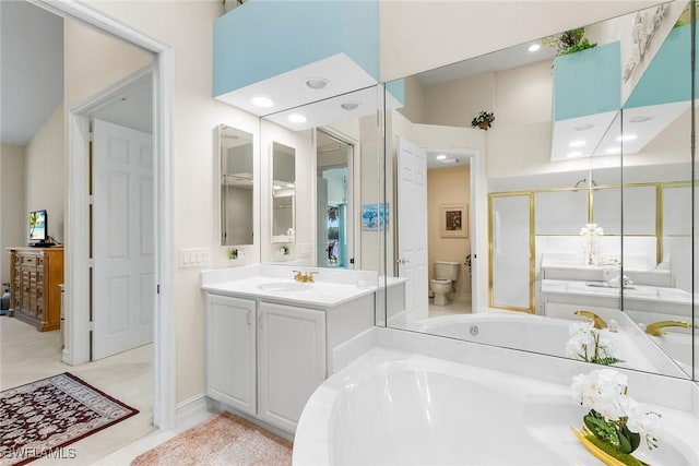 5979 Trophy Dr Unit 1604, Naples, FL 34110 - bathroom featuring toilet, vanity, a tub to relax in, and recessed lighting