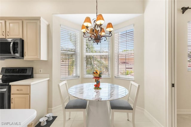 5979 Trophy Dr Unit 1604, Naples, FL 34110 - dining room featuring a chandelier, baseboards, and light tile patterned floors