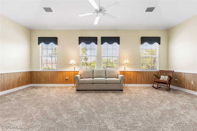 5979 Trophy Dr Unit 1604, Naples, FL 34110 - sitting room with plenty of natural light, a wainscoted wall, carpet floors, ceiling fan, and wooden walls