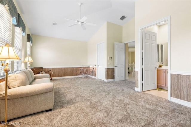 5979 Trophy Dr Unit 1604, Naples, FL 34110 - sitting room with a wainscoted wall, light carpet, high vaulted ceiling, a ceiling fan, and wooden walls