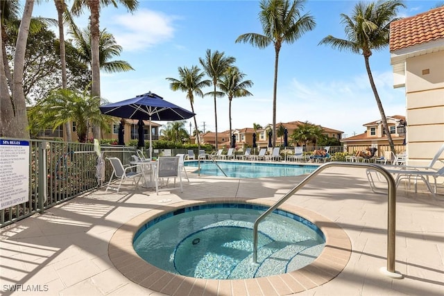 5979 Trophy Dr Unit 1604, Naples, FL 34110 - community pool featuring a community hot tub and a patio