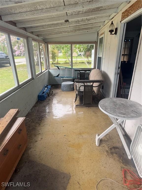 sunroom / solarium featuring lofted ceiling