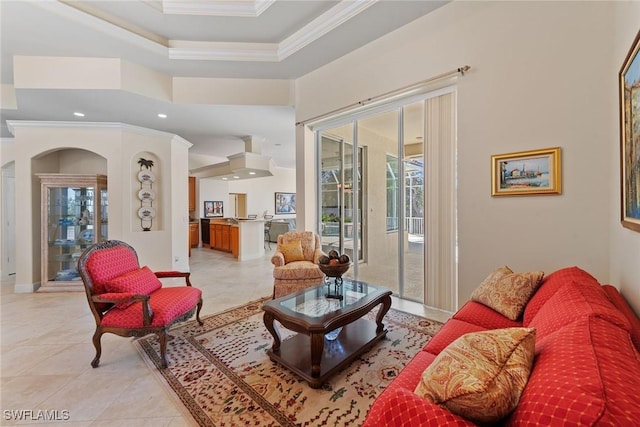 living area with a raised ceiling, recessed lighting, light tile patterned flooring, crown molding, and baseboards