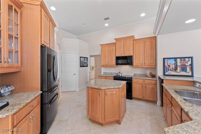 kitchen with visible vents, a center island, crown molding, light stone countertops, and black appliances