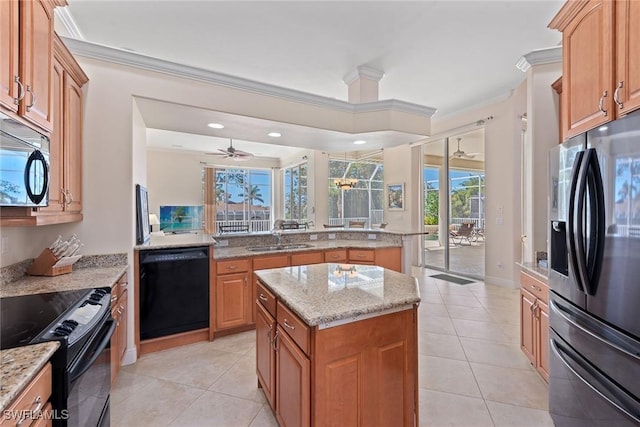 kitchen featuring a sink, black appliances, a center island, and crown molding