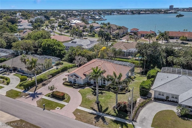 drone / aerial view with a residential view and a water view