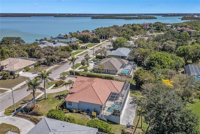 birds eye view of property with a water view and a residential view