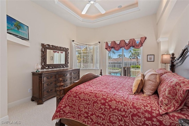 bedroom featuring access to exterior, ceiling fan, baseboards, carpet, and a tray ceiling