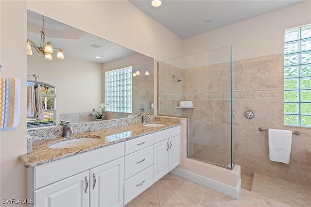 bathroom featuring double vanity, walk in shower, and a sink