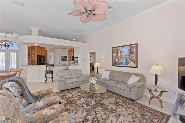 living room featuring baseboards, visible vents, light tile patterned flooring, ornamental molding, and ceiling fan with notable chandelier