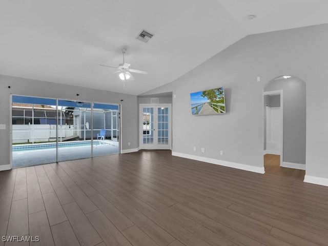 unfurnished living room with visible vents, a ceiling fan, wood finished floors, baseboards, and vaulted ceiling