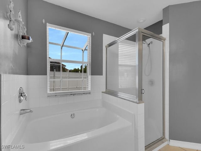 bathroom featuring a garden tub and a stall shower